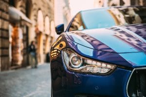 Close Up Headlight Of Blue Color Maserati Ghibli M157 Car Parked At Street