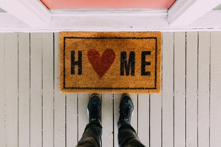 doormat that says the word home with a heart