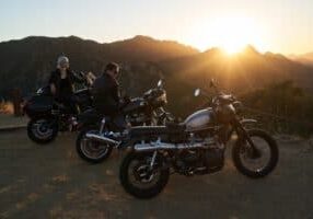 Group of motorcycles sitting on a lookout during sunset