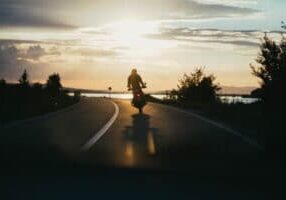 Person riding motorcycle during sunset