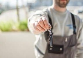 Person handing car keys to another