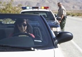 Police officer behind woman in convertible