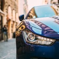 Close Up Headlight Of Blue Color Maserati Ghibli M157 Car Parked At Street